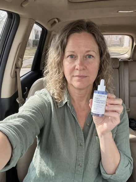 Elysium customer holding Copper Peptide Renewal Serum